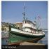 Large green and white tugboat on water