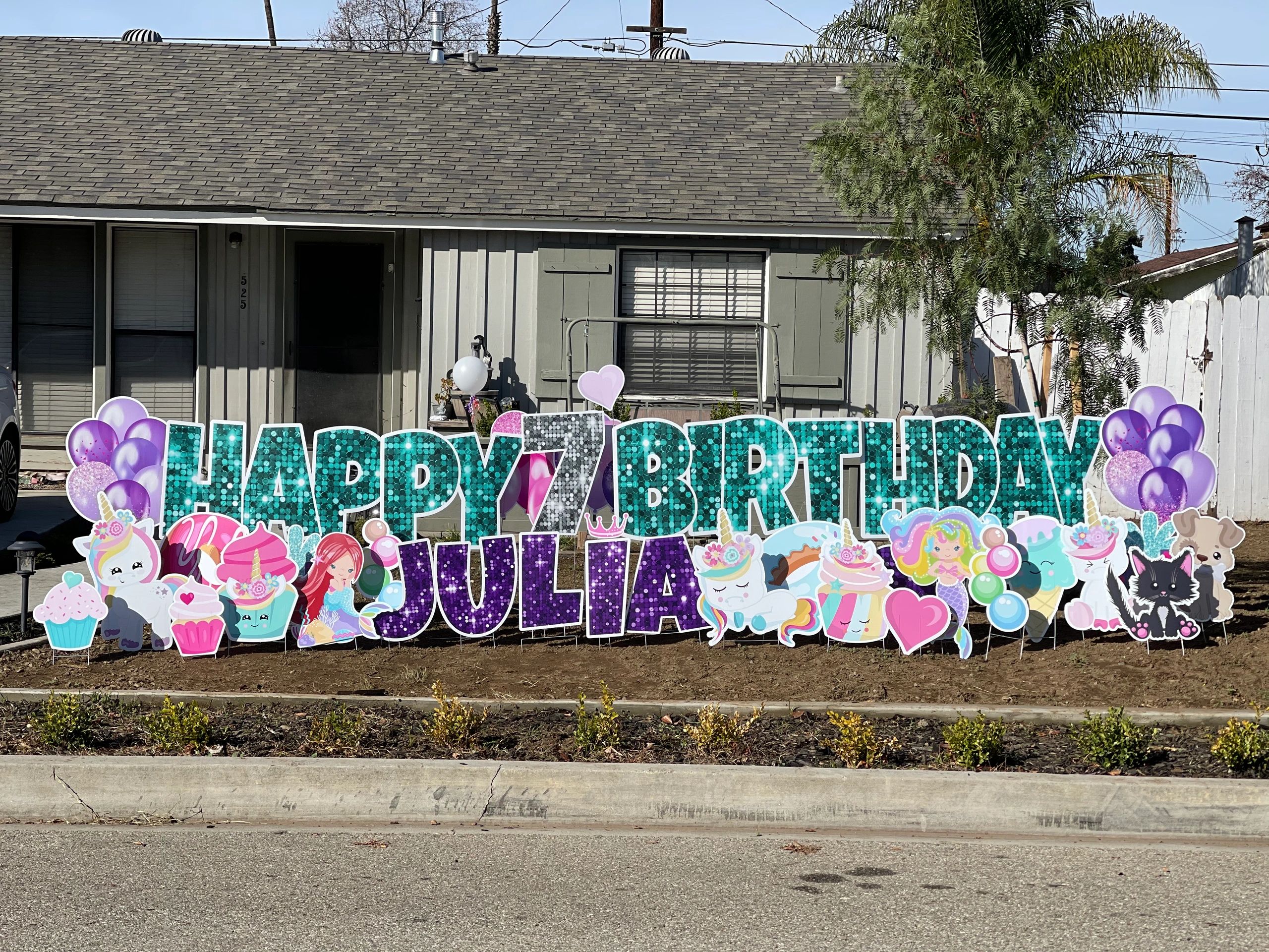 Teal sparkle Happy Birthday yard sign with mermaids, unicorns, balloons and presents.