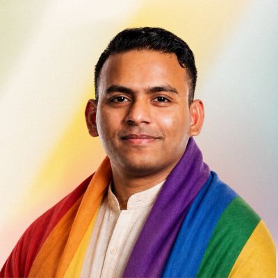 Man wearing a rainbow pride flag.