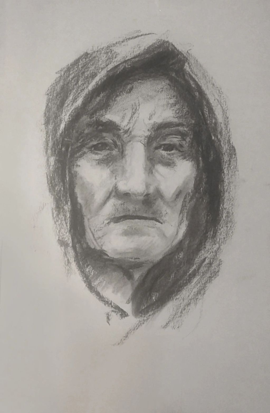 Charcoal sketch of an elderly person with a hood.