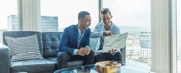 real estate agent presenting to a customer on a laptop