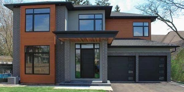 Modern two-story house with wooden and brick exterior.