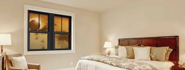 Cozy bedroom with a large bed and sunset view window.