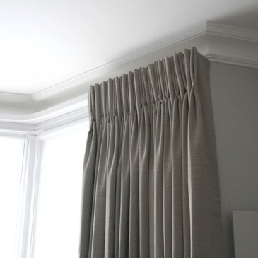 grey pencil pleated curtains fitted on a track in stratford upon avon