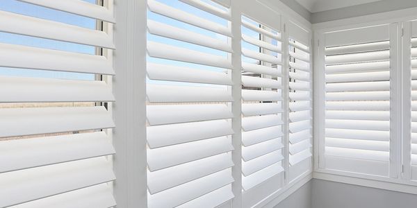 Faux Wood Shutters with blue sky in the background