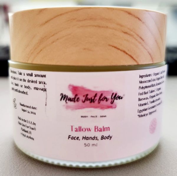 Tallow balm for face, hands, and body in a 50ml jar with wooden lid.