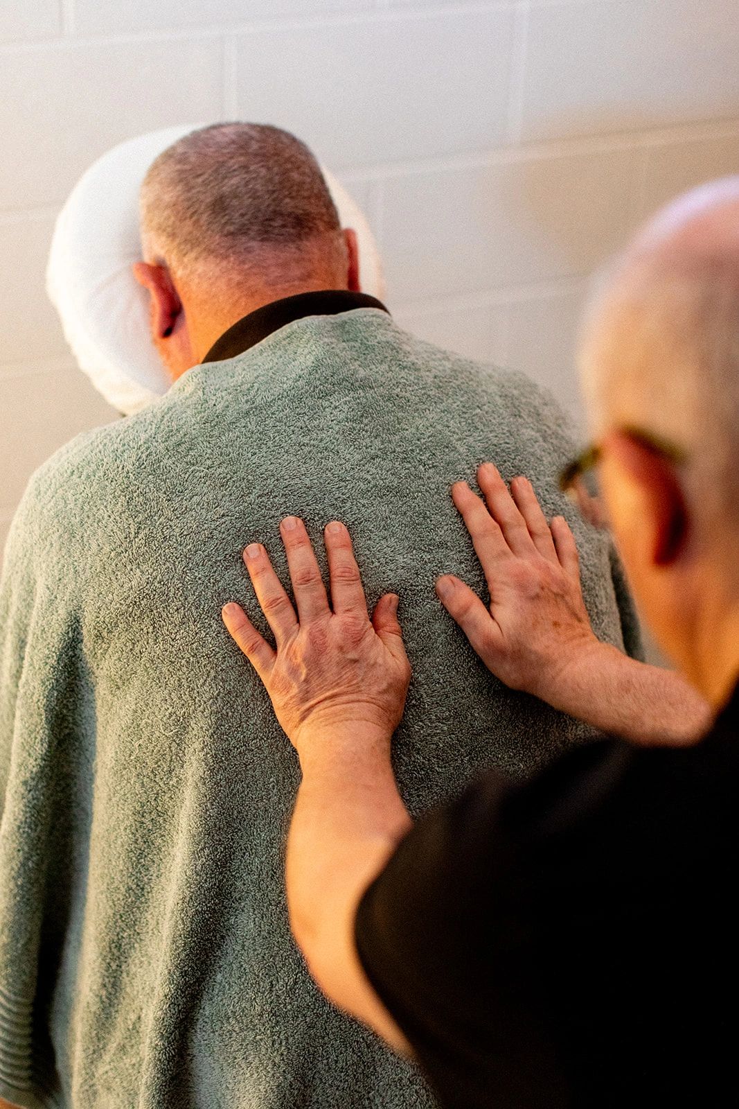 Seated chair massage relieving tension in the neck, shoulders and upper back.