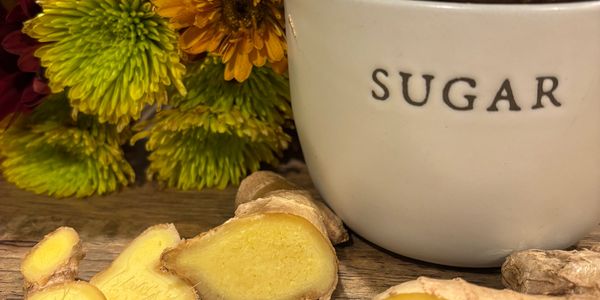 Sugar bow and ginger with background of flowers