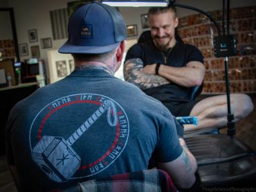 Man getting a tattoo in a studio.
