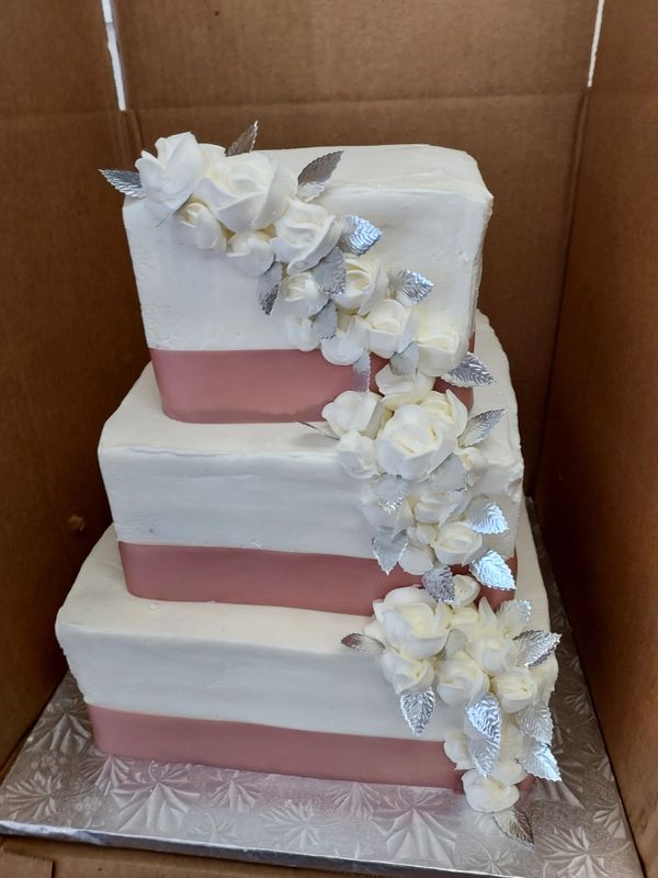 3 tiered pink and white wedding cake 