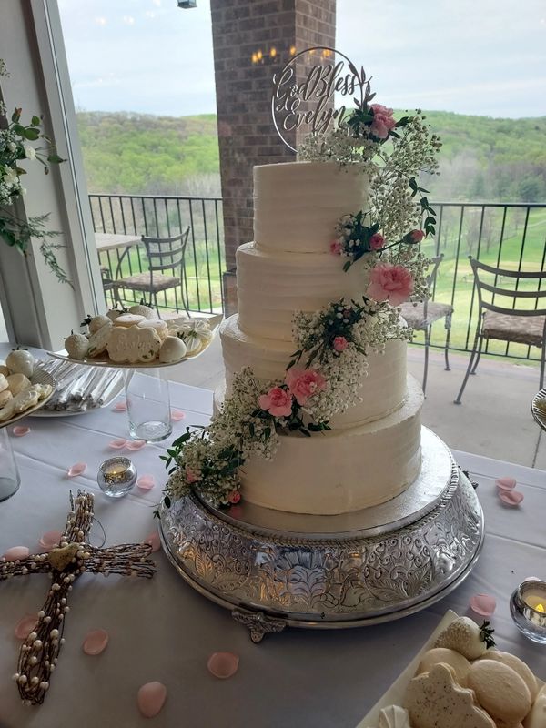 Four tiered wedding cake with fresh flowers