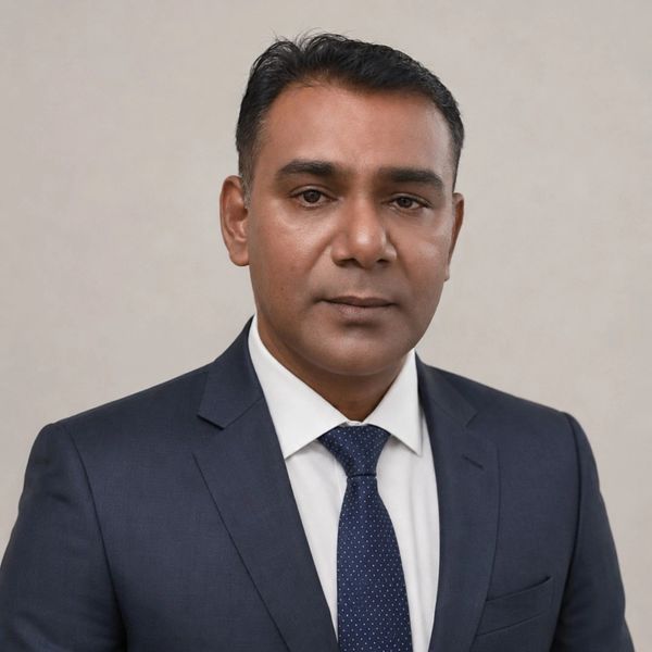 Professional man in a navy blue suit and tie.