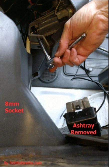 8mm socket on one of the radio bolts. The wrench goes through a hole in the ashtray bracket to access the bolts - PHOTO FROM ROBROBINETTE.COM 8mm socket on one of the radio bolts. The wrench goes through a hole in the ashtray bracket to access the bolts - PHOTO FROM ROBROBINETTE.COM