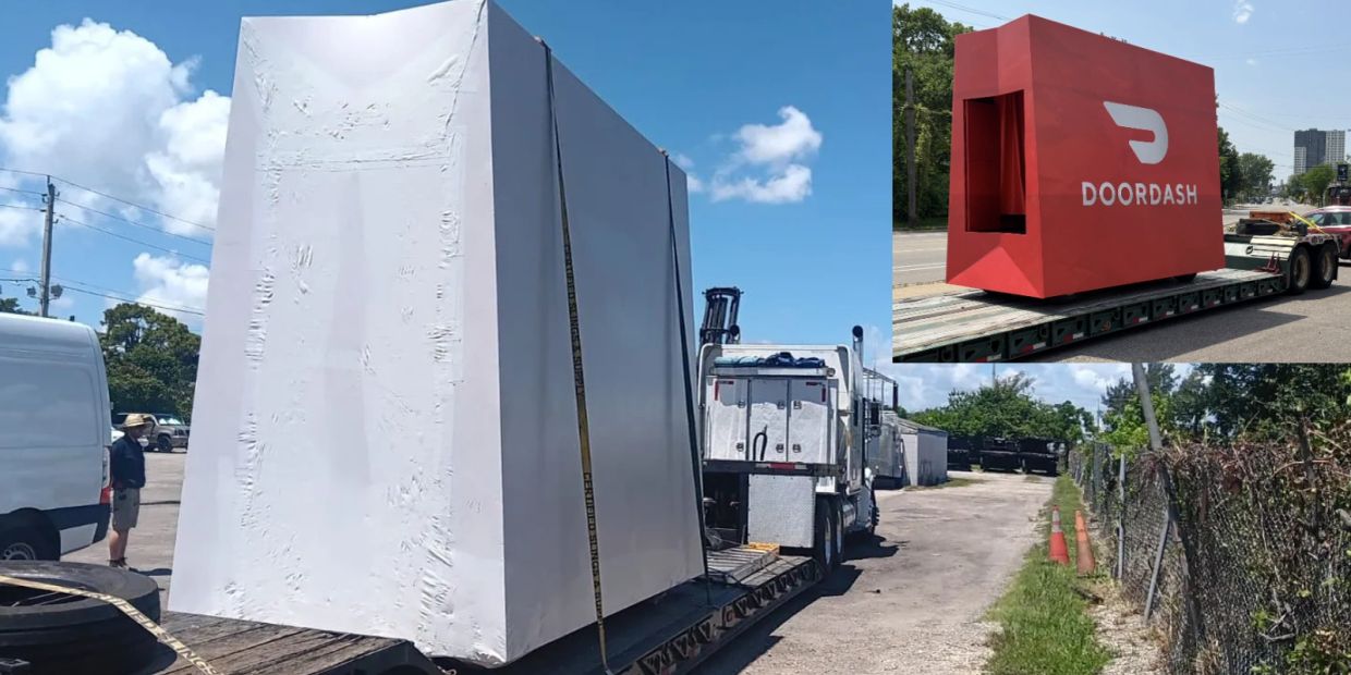 Large DoorDash delivery locker being transported on a truck.