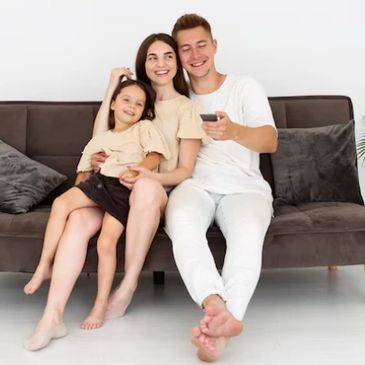 family sat on a freshly cleaned sofa