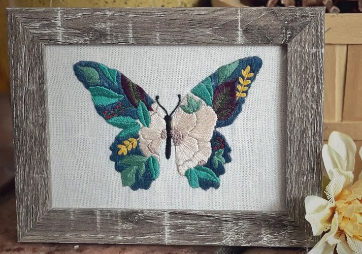 Wood framed floral butterfly hand embroidery. 