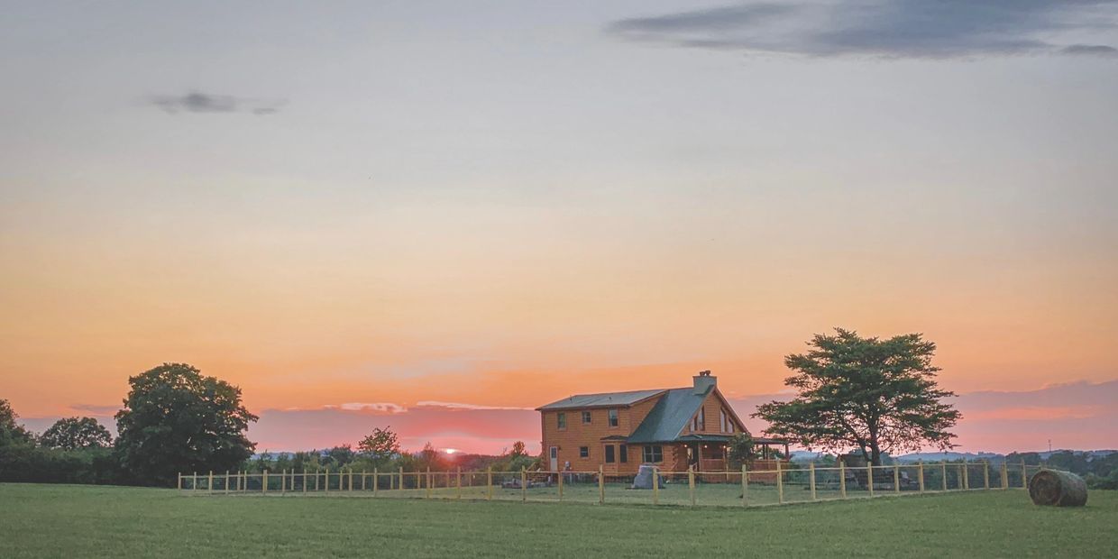 Tennessee log cabin on a hill at sunset. This was our original farm, we are now located in Wisconsin.