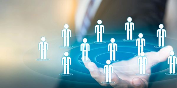 Digital network of human icons floating above a hand, symbolizing connectivity.