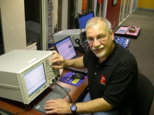 Man operating electronic testing equipment.