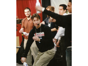 Scott Young teaching flair bartending while wearing a microphone headset.