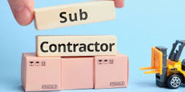 A large box with tiles above with the written words "Sub contractor" and a toy tractor next to it.