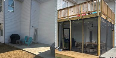 Backyard patio before and after screened porch addition.