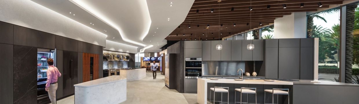 Modern kitchen showroom with sleek design and appliances.