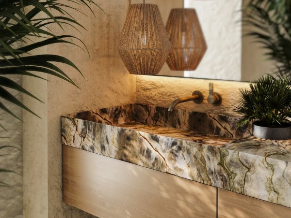 Stylish marble sink with wooden cabinet and hanging lamps.