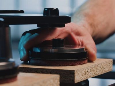 Person using a sanding machine on wood.