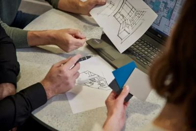People reviewing architectural plans and color swatches.