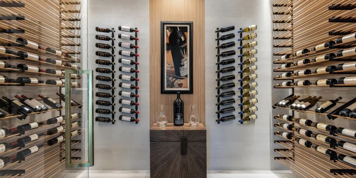 Modern wine cellar with bottles displayed on wooden racks.