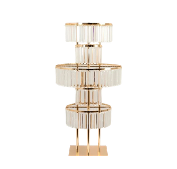 A modern, geometric table lamp with a gold base and multiple glass segments.