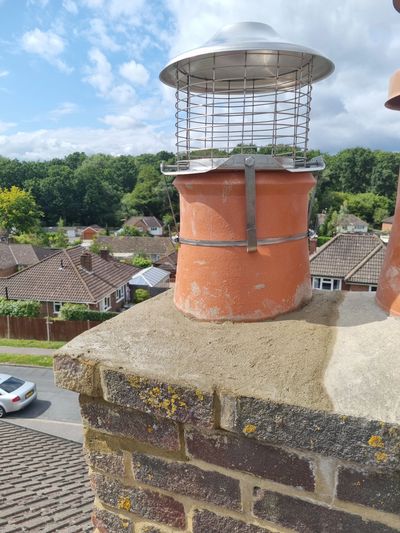 Ventilated chimney cap on a brick chimney.
