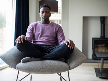 A man sitting on a chair meditating