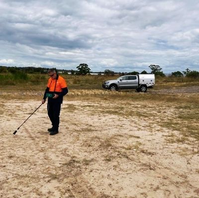 Man using gas reader to detect surface gas from fugitive emissions