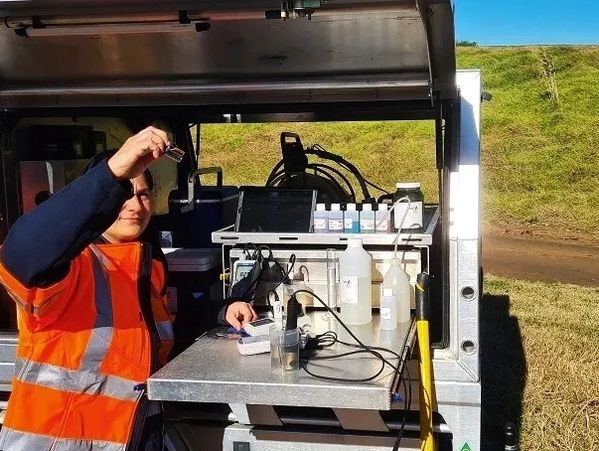 Field techinician performing Turbidity test in the field using mobile lab. 