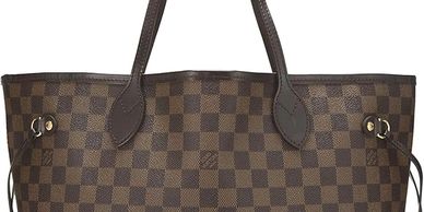 Brown checkered tote bag with dark brown handles and side ties.