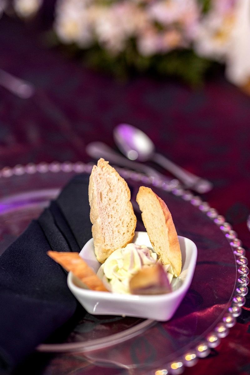 Bread slices with whipped butter served on a decorative plate.