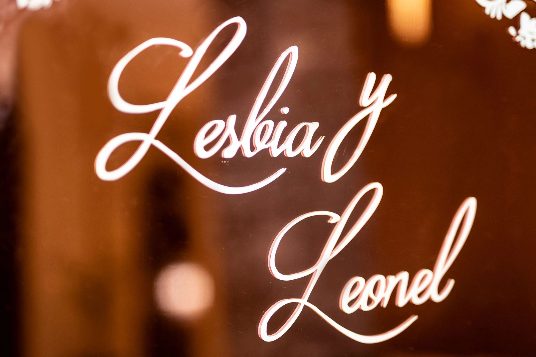 Elegant cursive text of names Lesliea Y and Leonel on a reflective surface.