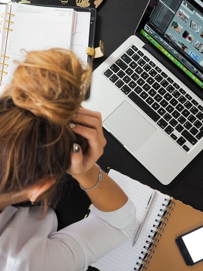 An office worker appearing distracted and overwhelmed. 