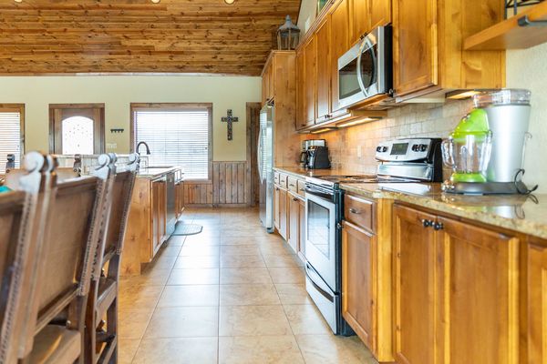 This is an image of a kitchen in a vacation house in Concan, TX.