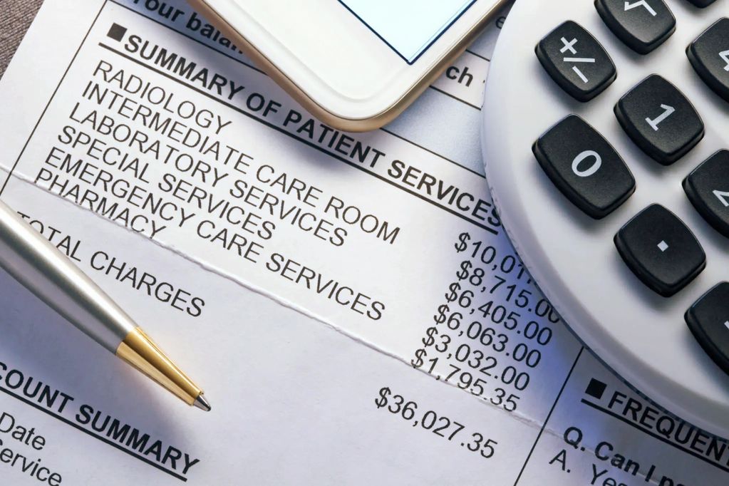 Medical bill summary with costs, pen, phone, and calculator.