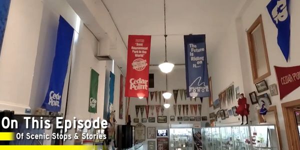 Interior view of Cedar Point memorabilia with colorful banners and display cases.