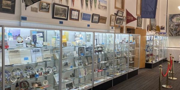 Display cases filled with memorabilia and awards in a museum-like setting.