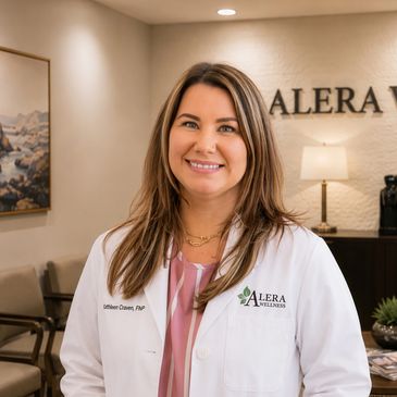 Female healthcare professional in white coat smiling in clinic.