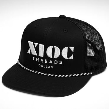 Black trucker hat with white embroidered text and rope detail.