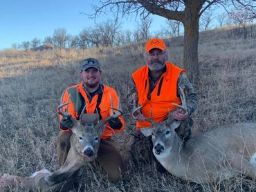 Picture of father and son (paid hunters) with their deer on Bail Ranch. 