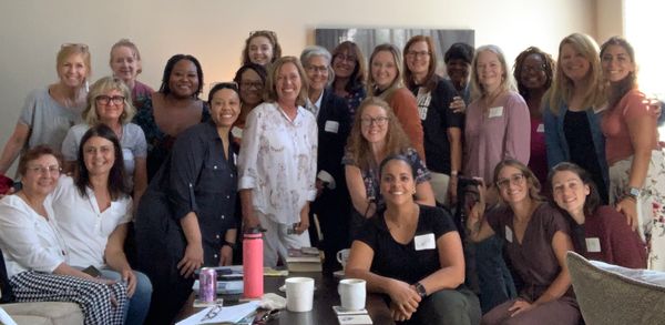 Group of women gathered indoors for a meeting or workshop.