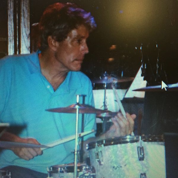 Man playing drums indoors.