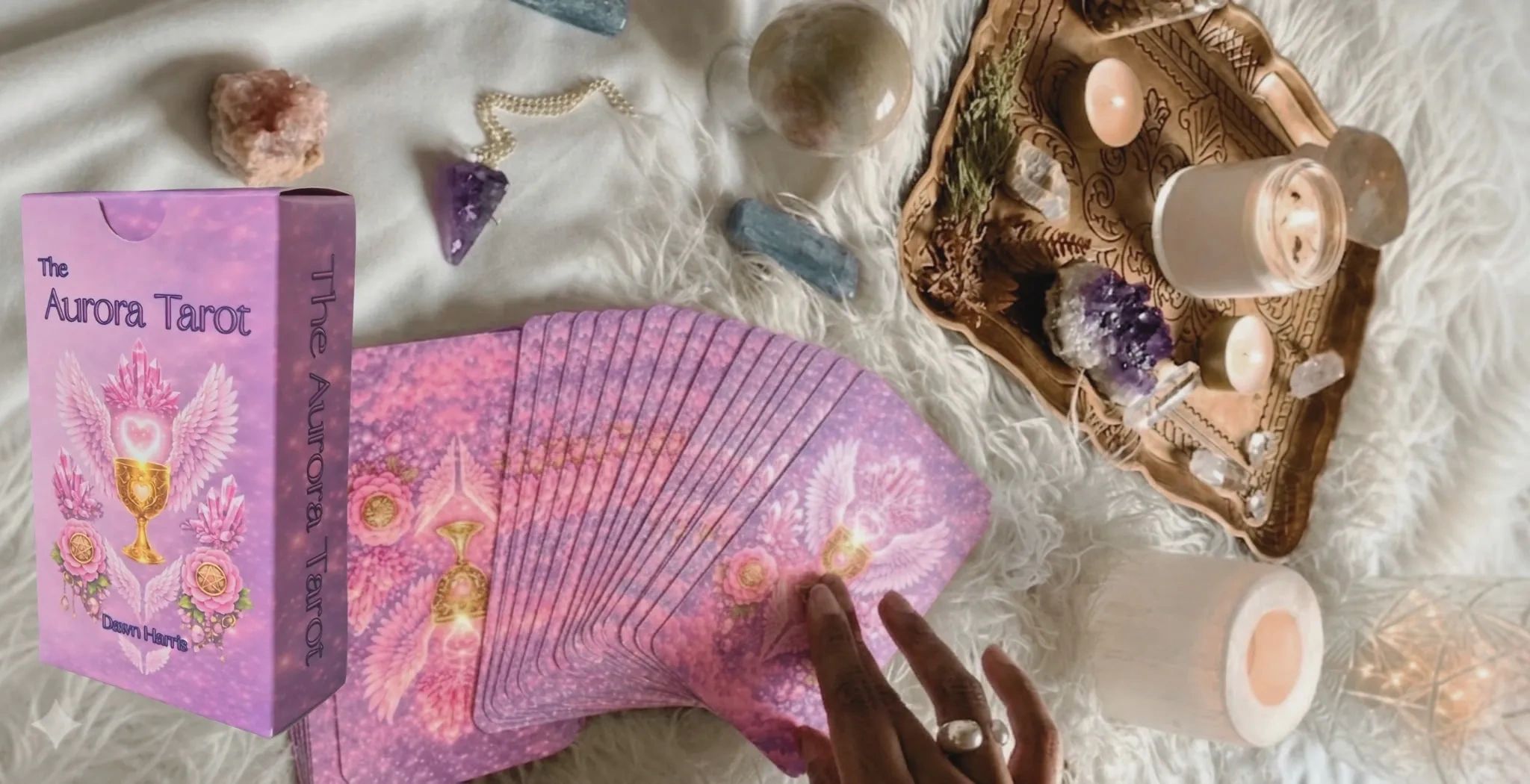Tarot cards, crystals, and candles set for a spiritual reading.